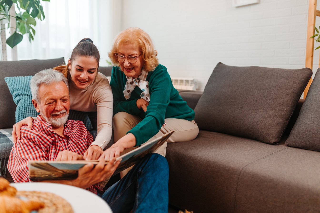 Old photo album makes parents and their daughter happy.